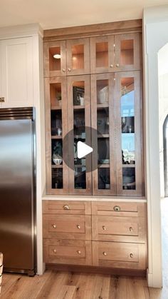 a kitchen with wooden cabinets and stainless steel refrigerator freezer next to it's glass front doors