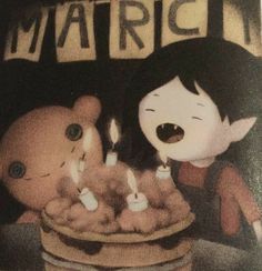 two children are sitting in front of a basket with candles