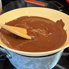 a wooden spoon stirring chocolate in a bowl