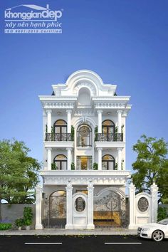 a large white building with lots of windows and balconies on the top floor