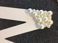 a pair of scissors with pearls attached to them