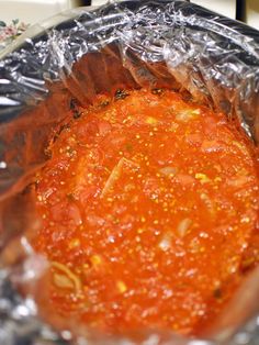 an aluminum foil container filled with marinara sauce