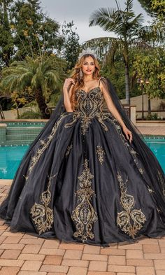 Black quinceanera a-line ball gown with gold lace embroidery and sweetheart neckline. Black And Gold Wedding Dress, Quinceanera Dresses Black, Vestido Charro, Gown With Cape, Quinceanera Dresses Gold, Black Quinceanera Dresses, Feeling Secure, Quinceñera Dresses, Cape Gown