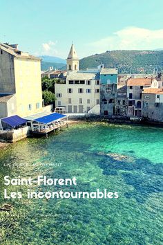 the water is crystal blue and clear with buildings in the background that read saint - florent les incontounnables