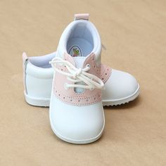 a pair of white and pink baby shoes