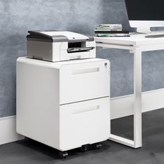 a computer desk with a printer on it