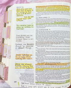 an open bible with colorful writing on it