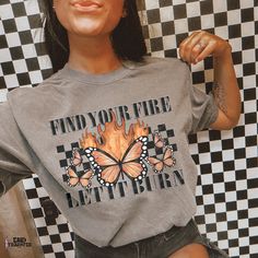 a woman wearing a t - shirt that says find your fire, let it burn