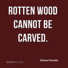 a quote that says rotten wood can not be carved chinese prove is written in white