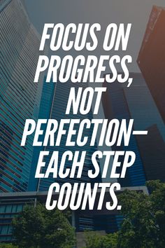 the words focus on progress, not perfection - each step counts in front of tall buildings