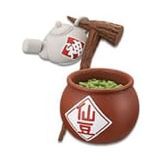 a brown pot with a hammer sticking out of it next to a white stuffed animal