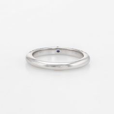 Elegant Adolfo Courrier stacking ring, crafted in 18 karat white gold.   One estimated 0.05 carat sapphire, accented with 36 estimated 0.01 carat round brilliant cut diamonds totaling an estimated 0.36 carats (estimated at G-H colour and VS2 clarity).    The house of Adolfo Courrier is a highly regarded Italian jeweller known for a brilliant contrast of colour and texture. The clean contemporary design of the ring is great worn alone as a simple band or stacked with your other rings.  The ring i Single Diamond Anniversary Bands, Anniversary Diamond Band With Single Diamond, Anniversary Bands With Single Diamond, Refined Platinum Round Ring, Refined Round Platinum Rings, Classic Sapphire Birthstone Ring, Classic Sapphire Halo Ring, Formal Sapphire Diamond Ring In Platinum, Timeless Sapphire Promise Ring With Round Band