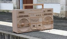 a cardboard boombox sitting on the sidewalk