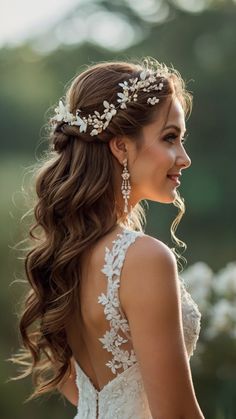 a woman wearing a wedding dress with flowers in her hair and an elegant headpiece