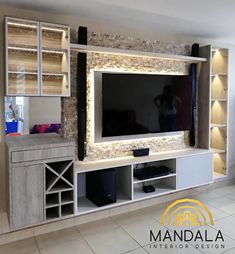 a living room with a large tv and entertainment center in the wall, along with shelving units