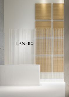 a white counter in front of a wall with the name kanebo on it