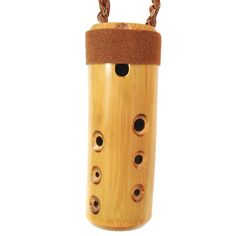 a wooden birdhouse with four holes in it's front and two chains on the back