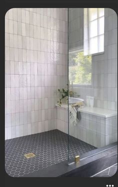 a white tiled bathroom with a walk in shower