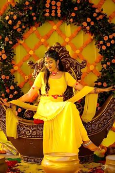 a woman sitting on top of a boat with flowers around her neck and hands in the air