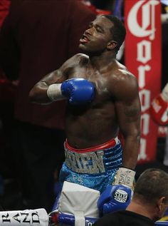 a man with blue boxing gloves standing next to each other