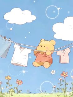 a teddy bear hanging out to dry on a clothes line with flowers and clouds in the background