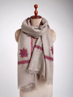 Experience pure luxury with the Handloomed Grey Embroidered Pashmina Wrap, blending traditional craftsmanship with modern sophistication. Crafted from the finest pashmina, this wrap offers an incredibly soft and warm feel, perfect for adding a touch of sophistication to any outfit. The sophisticated grey base provides a versatile canvas, while the exquisite hand-embroidered traditional motifs enhance its classic charm. Each detail reflects meticulous craftsmanship, merging traditional artistry with a modern fashion sensibility. This wrap not only provides exceptional comfort but also elevates your style with a sense of opulence and grace, making it an essential piece for any discerning wardrobe. Dimensions: 100 x 200 cm. Traditional Embroidered Winter Scarves, Embroidered Pashmina Shawl For Winter, Embroidered Pashmina Scarves For Winter, Winter Embroidered Pashmina Scarves, Handloom Pashmina Shawl For Winter, Traditional Pashmina Shawl With Resham Embroidery For Winter, Traditional Handloom Pashmina Shawl For Winter, Beige Embroidered Pashmina Scarf, Wardrobe Dimensions