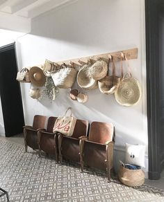 several chairs and hats hanging on the wall