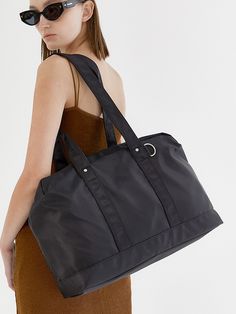 Editor's NotesHY-PHEN's versatile yet trendy tote bag can be your go-to bag with a simple design. It has enough storage and pockets.- Tote bag- D ring on the strap- Zipper closure- Enough storage and pockets- Versatile and comfortable itemMeasurements(in.)One size- Width: 16.53 in.- Height: 11.81 in.- Depth: 4.72 in.Composition & Care- 100% Nylon- Hand wash in cold waterDesigner- by HY-PHEN Everyday Nylon Satchel With Double Handle, Large Capacity Nylon Satchel For Everyday Use, Modern Gym Bag For Everyday Use, Everyday Tote Gym Bag, Everyday Tote Gym Bag With Top Carry Handle, Everyday Gym Bag With Double Handle, Everyday Gym Bag With Large Capacity And Double Handle, Everyday Use Tote Gym Bag, Everyday Gym Tote Bag With Adjustable Strap