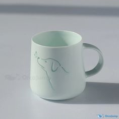 a white coffee cup with a dog drawn on it