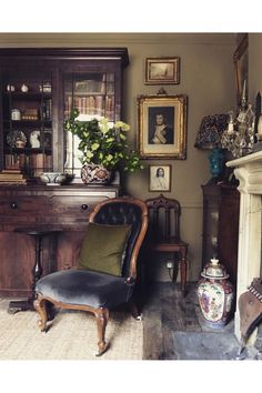 an old fashioned chair sits in front of a fireplace