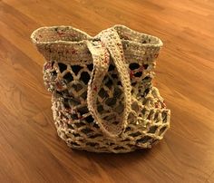 a crocheted bag sitting on top of a wooden floor