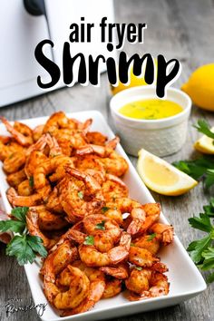 air fryer shrimp on a plate with lemons and parsley next to it