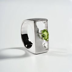 Broken pieces hold a story. You can't find wisdom staying all shiny and new.Details:Silver 925 Stones: PeridotPlating: White RhodiumWidth: 11 mmBand wide: 5 mmLength: 22 mmWeight: 7.93 g Modern Peridot Jewelry For Formal Occasions, Silver Peridot Rings With Polished Finish, Modern Peridot Rings For Anniversary, Modern Polished Rings With May Birthstone, Modern Sterling Silver Green Rings, Modern Green Sterling Silver Rings, Modern Green Jewelry For Promise Occasion, Modern Silver Jewelry With Peridot, Modern Silver Peridot Jewelry