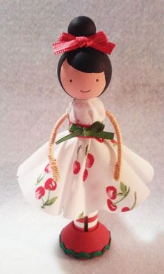 a figurine with a red bow on her head