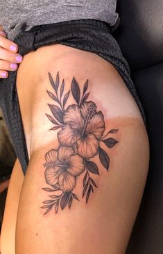 a woman's thigh with flowers on it