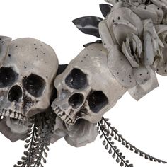 there are two skulls with flowers on their heads