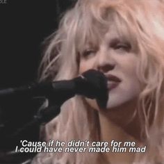 a woman singing into a microphone with the words cause if he didn't care for me i could have never made him mad