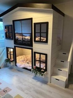 a doll house with stairs leading up to the second floor and two beds in it