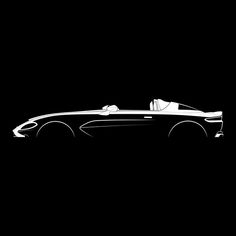 a black and white photo of a car on a dark background with the top down