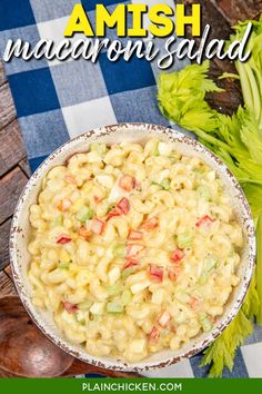 a bowl filled with macaroni salad on top of a blue and white checkered table