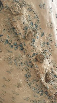 an old dress with blue and white flowers on it