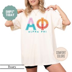 a woman wearing a t - shirt with the word aloha phi on it