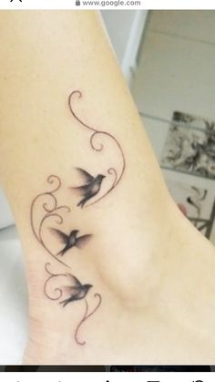 a woman's foot with birds on it and swirls around the ankles,