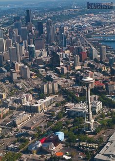 an aerial view of a city with tall buildings and water in the foreground is shown