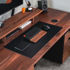 a computer desk with a keyboard and mouse