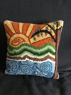 a decorative pillow with an image of the sun on it