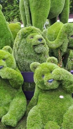 there are many green teddy bears made out of grass