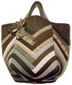 a brown and white striped bag with a flower on the front, sitting against a white background