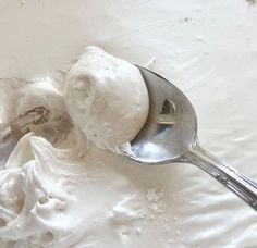 a spoon full of ice cream sitting on top of a table