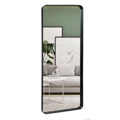 a large mirror reflecting a living room scene